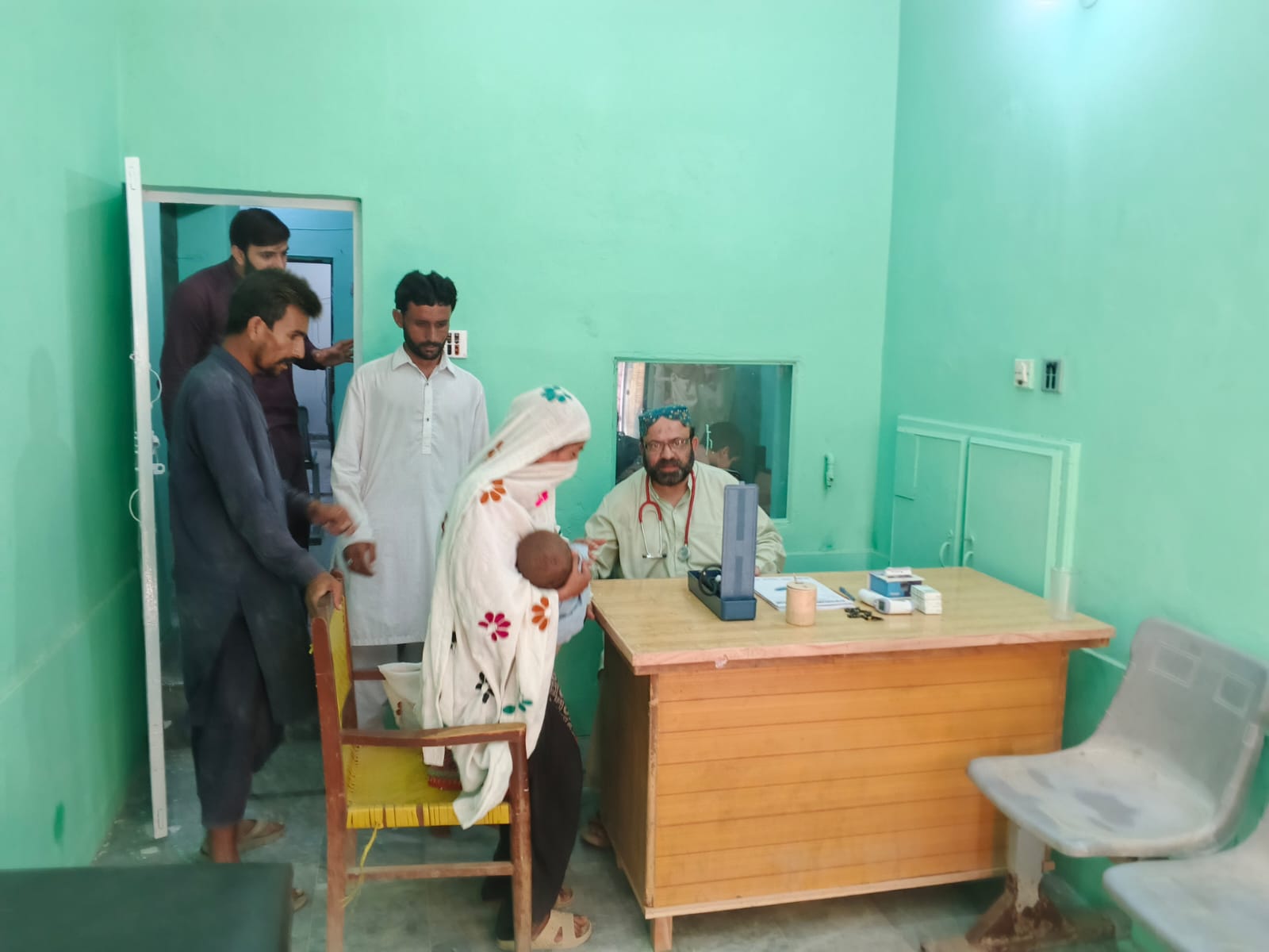 Doctor consulting a mother and baby at Bukhari Clinic